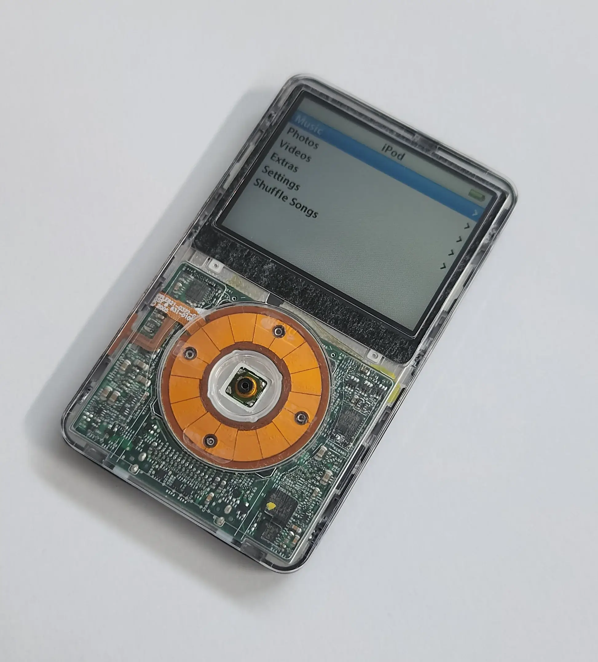 A third generation iPod Classic playing music.